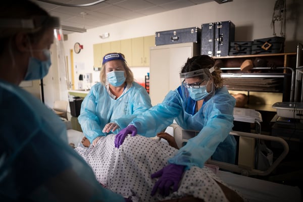 Student adjusts patient in skills lab