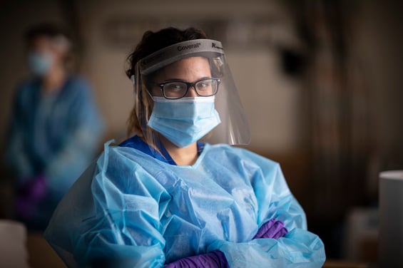 Student in full PPE crossed arms