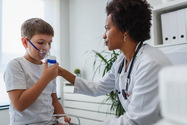 Nurse giving oxygen to child