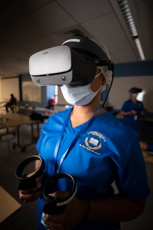 Labouré Student wearing VR headset and holding hand controllers performs a scenario