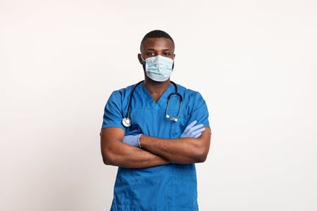 Nurse in Scrubs with face mask and gloves