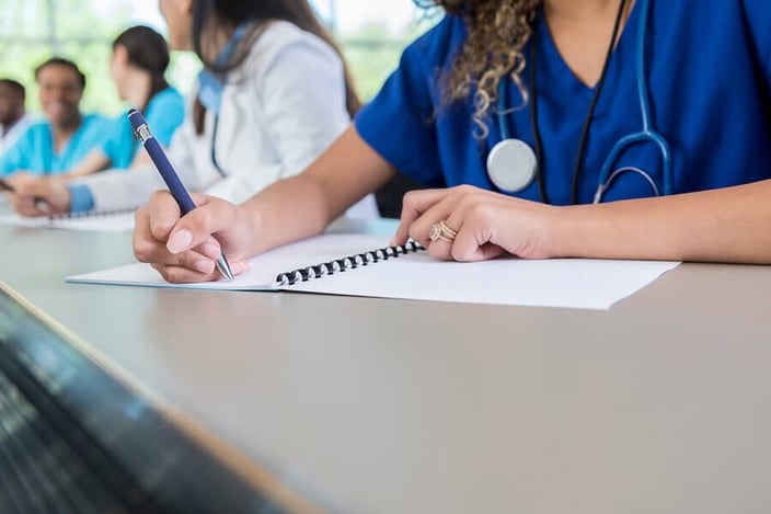 how-long-is-nursing-school--medical-student-writes-in-class-workbook-optimized